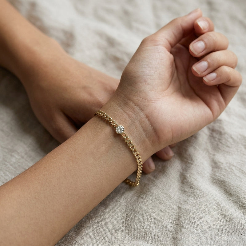 Worn: Bezel-Set Solitaire Curb Link Bracelet · 0.07–0.25 ct — AI-rendered styling image
