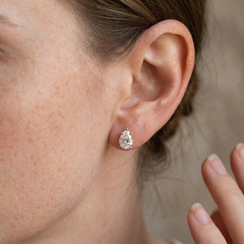Worn: Pear 5-Prong Stud Earrings · 0.38–2 ct — AI-rendered styling image