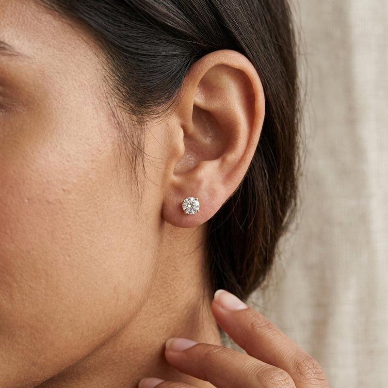 Worn: Round 3-Prong Stud Earrings · 0.5–1 ct — AI-rendered styling image