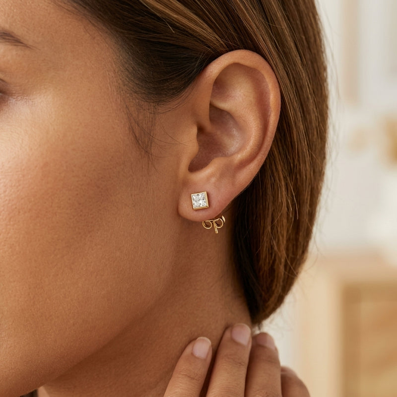 Worn: Square Bezel-Set Stud Earrings · 0.13–0.63 ct — AI-rendered styling image