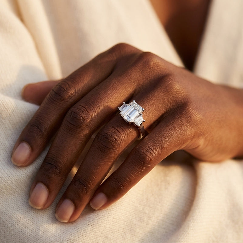 Worn: Three-Stone Engagement Ring · 0.5–1 ct — AI-rendered styling image