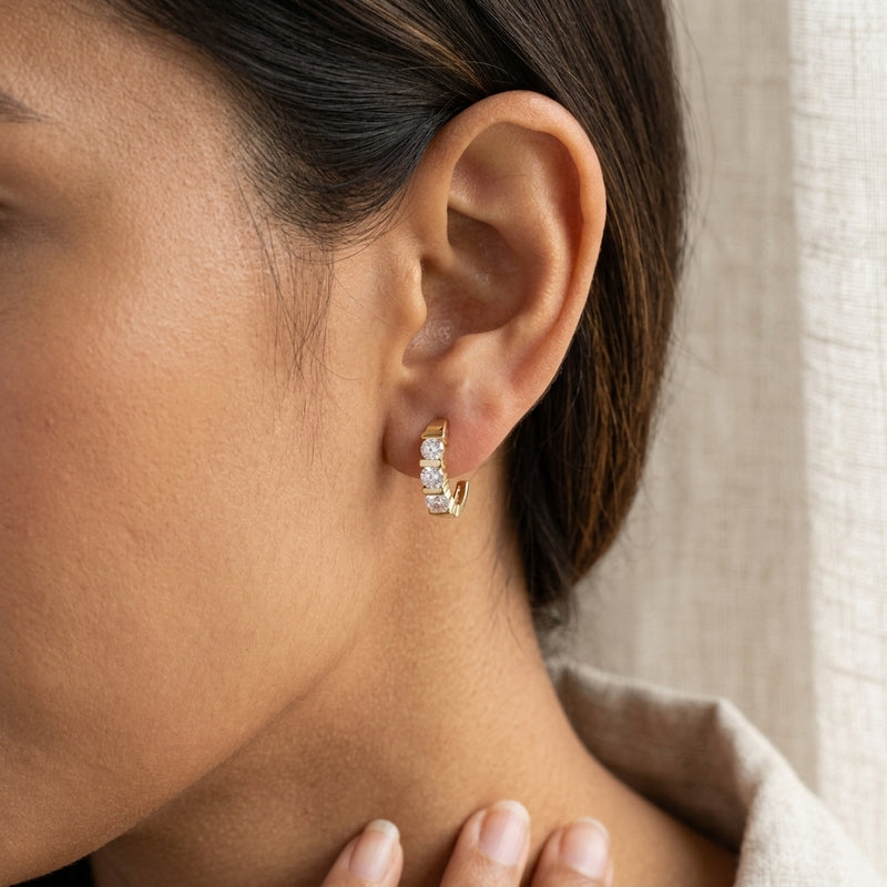 Worn: Three-Stone J-Hoop Earrings · 0.5–1.38 ct — AI-rendered styling image